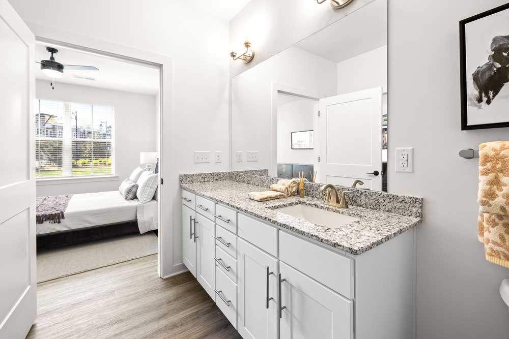 Bathroom vanity with view into bedroom